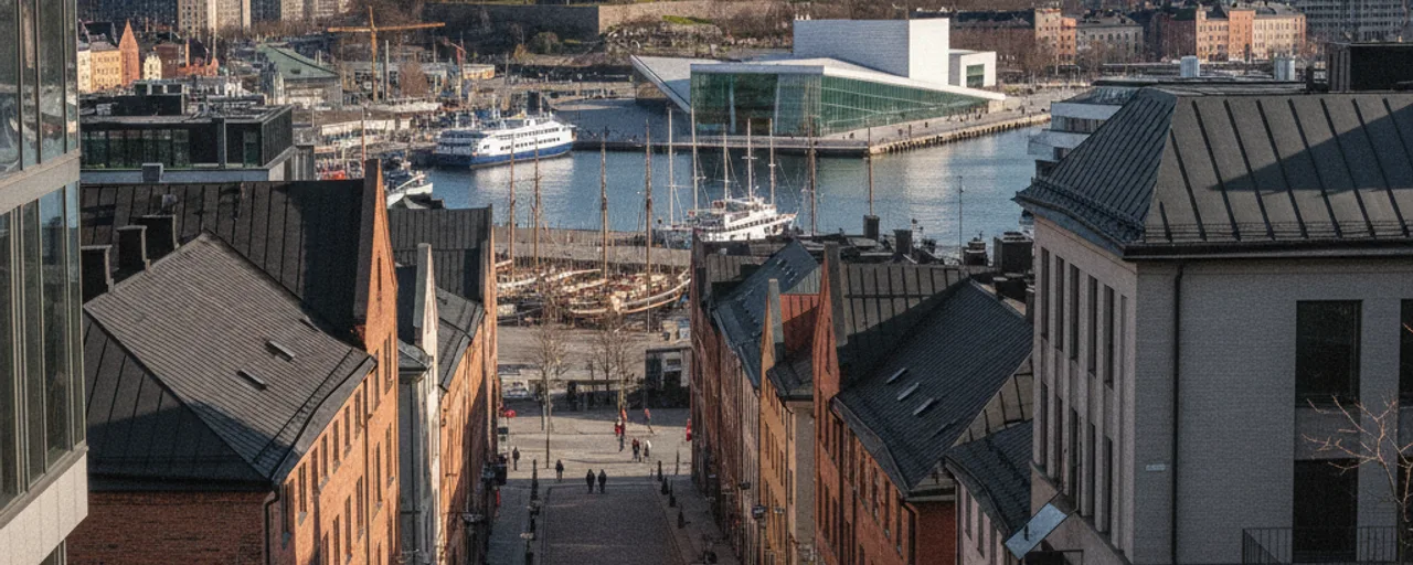 Elevated view of Oslo's harbor: Opera House, ferry, traditional buildings and a lively street, reflecting Oslo sustainable travel options.